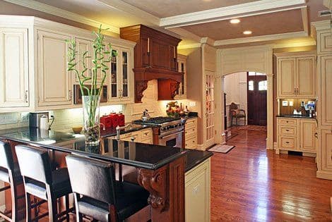Elegant kitchen with dark wood cabinetry, granite countertops, and modern appliances.