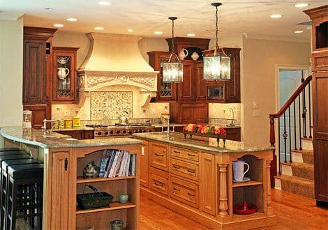 Elegant modern kitchen with dark wooden cabinets, granite countertops, and decorative lighting.