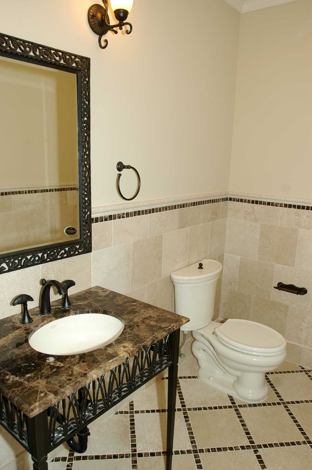 Elegant bathroom with marble sink, wooden vanity, and tiled flooring. Classic design elements.