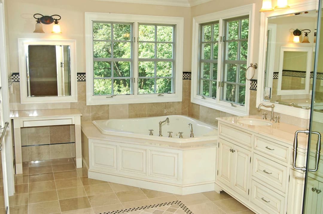 Bright modern bathroom with a soaking tub, double sink vanity, and large windows for natural light.