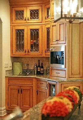 Elegant kitchen with wooden cabinets, granite countertops, and modern appliances.