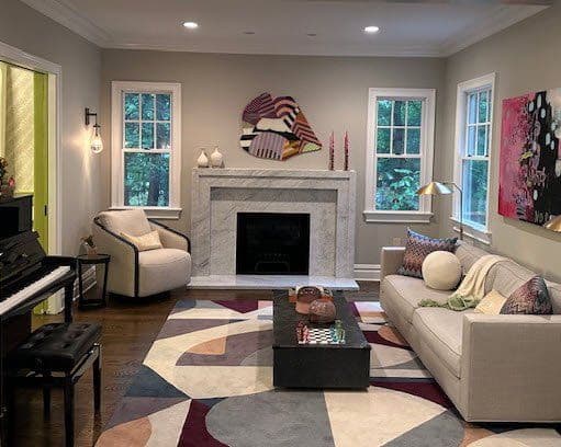 Modern living room with colorful abstract art, piano, and stylish furniture. Cozy and inviting atmosphere.