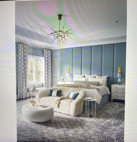 Modern bedroom featuring blue accent wall, stylish chandelier, and elegant furnishings.