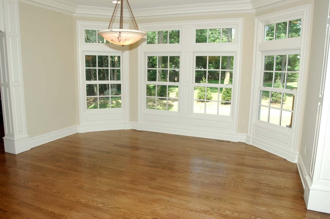Bright, modern room with large windows and hardwood floor, perfect for natural light.