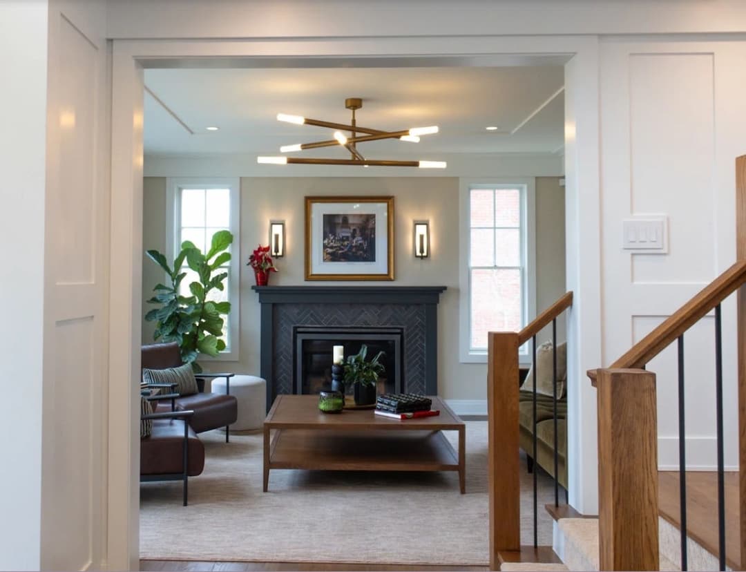 Modern living room with fireplace, stylish furniture, plants, and contemporary lighting.