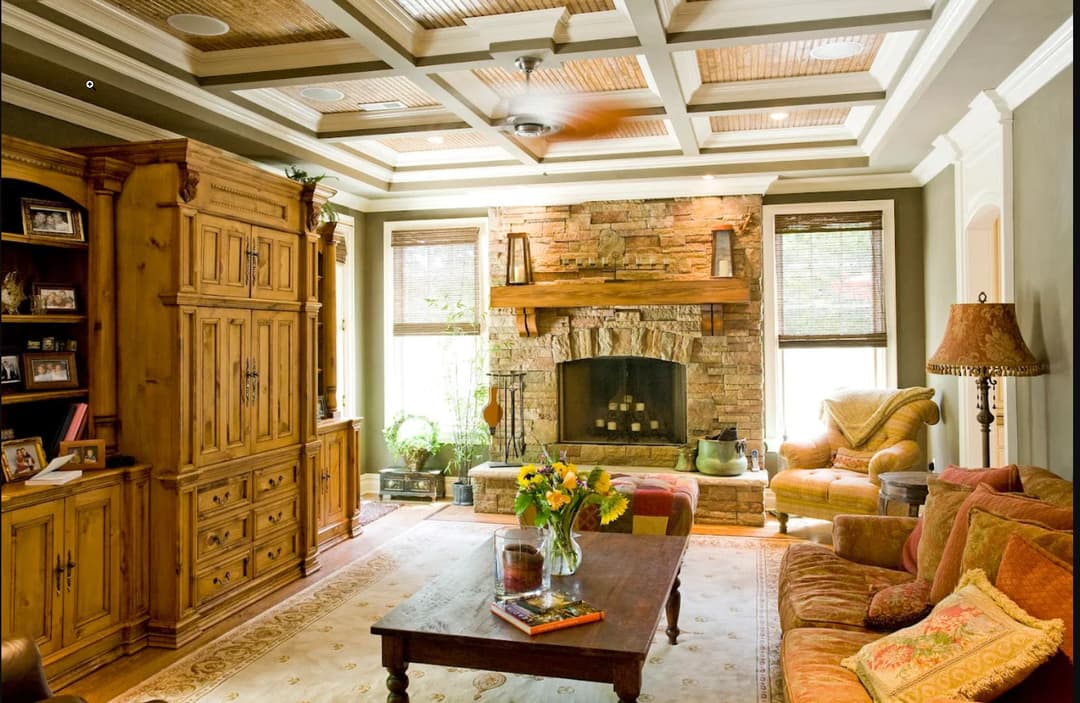 Cozy living room with stone fireplace, wooden furniture, and elegant decor elements.